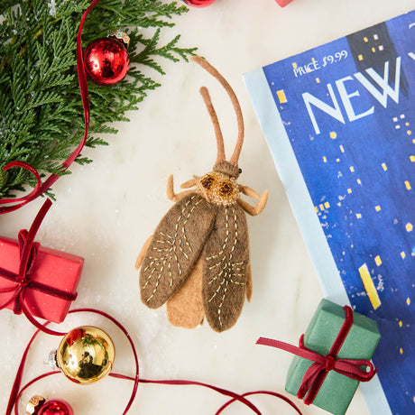 Celebrate one of nature’s most resilient and fascinating creatures with our Cockroach Ornament.  Lovingly needle-felted from natural wool, this tiny explorer features carefully stitched wings, long antennae, and a softly sculpted body that highlights the intricate beauty of this often-overlooked insect. 
