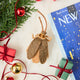 Celebrate one of nature’s most resilient and fascinating creatures with our Cockroach Ornament.  Lovingly needle-felted from natural wool, this tiny explorer features carefully stitched wings, long antennae, and a softly sculpted body that highlights the intricate beauty of this often-overlooked insect. 