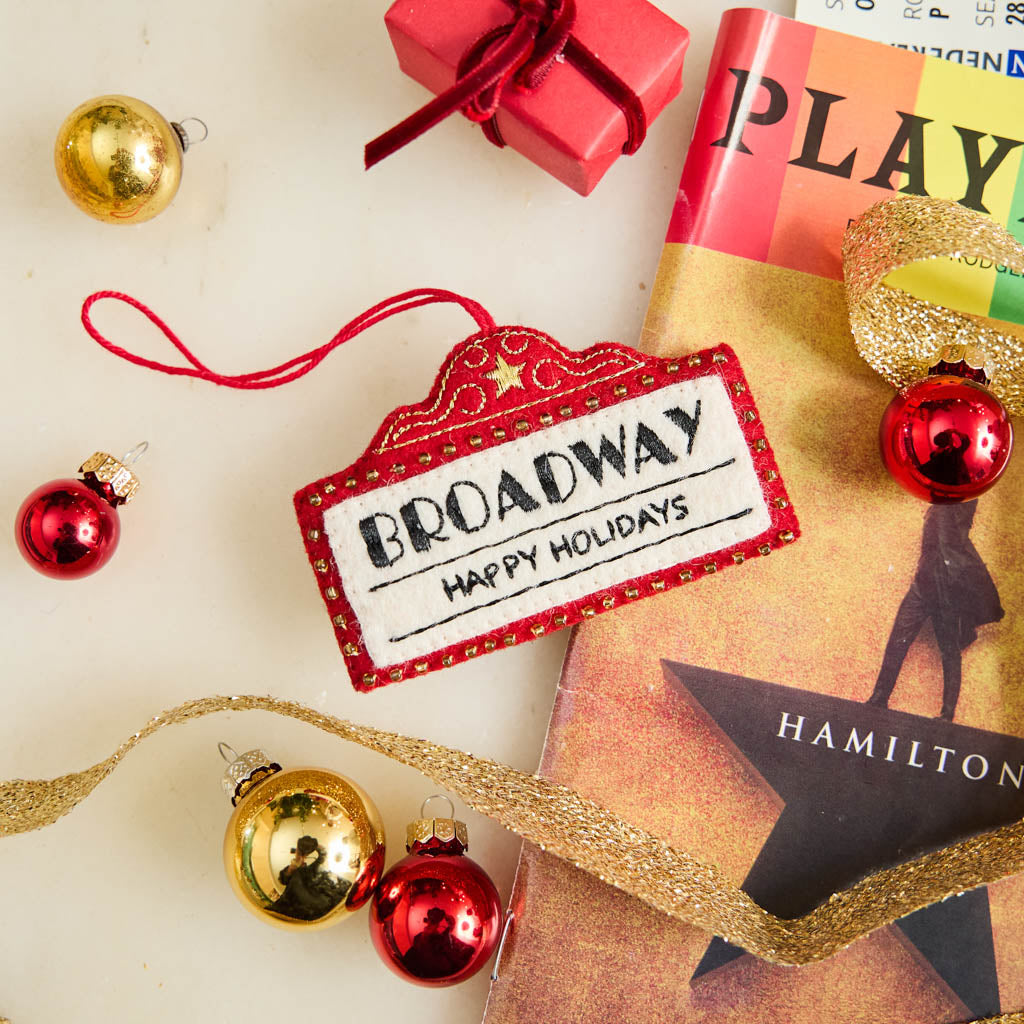 Capture the magic of Broadway with our handmade Broadway Marquee Ornament, a festive felt tribute to New York City's legendary Theater District and the unforgettable joy of live performance.
