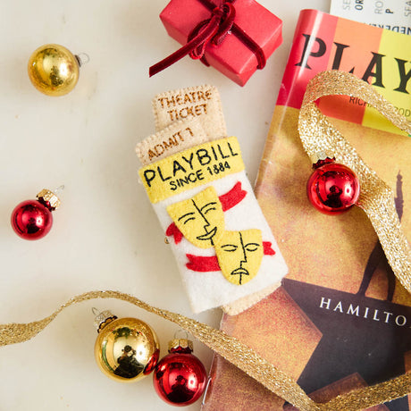 Celebrate the magic of Broadway with our handmade Playbill Ornament, inspired by the iconic theater program and finished with a hidden "Bravo!" message to honor every unforgettable performance.