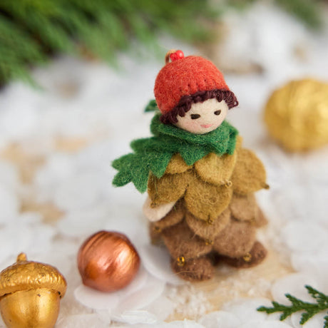 Waldorf-inspired, our Little Pinecone Kid Ornament captures the whimsical spirit of a woodland fairy tale. With its cute woolen bonnet, it's pine-green scarf and lovely layered pinecone petals and sweet as can be felted booties - this pinecone child is ready to capture woodland hearts.