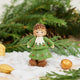 Inspired by the gentle wonder of Waldorf traditions, our Little Acorn Kid Ornament captures the whimsical spirit of a woodland fairy tale. Wearing an adorable felted acorn cap and a charming oak-leaf skirt.