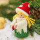 A magical little child of the forest, bringing good fortune, woodland wonder, and a sprinkle of fairy-tale enchantment into your home all year round! This sweet little red Amanita mushroom girl ornaments features a bright red felted mushroom cap, dotted with delicate white spots, and a skirt hemmed with felted green grasses. 