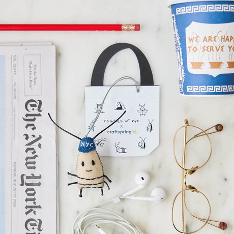 In collaboration with @roachesofnyc, we present to you our Roach Bag Charm, featuring a smile and a blue NYC beanie.