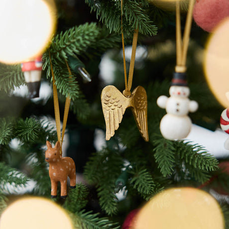 A set of eight hand-painted mini Christmas ornaments featuring nostalgic holiday icons, each finished with a golden satin ribbon and tucked into a reusable cotton gift pouch. Made to last and keep forever.