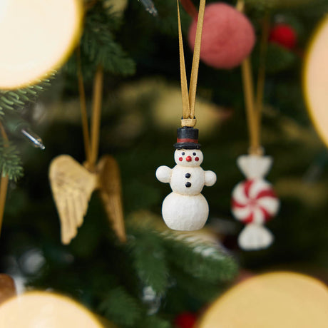 A set of eight hand-painted mini Christmas ornaments featuring nostalgic holiday icons, each finished with a golden satin ribbon and tucked into a reusable cotton gift pouch. Made to last and keep forever.