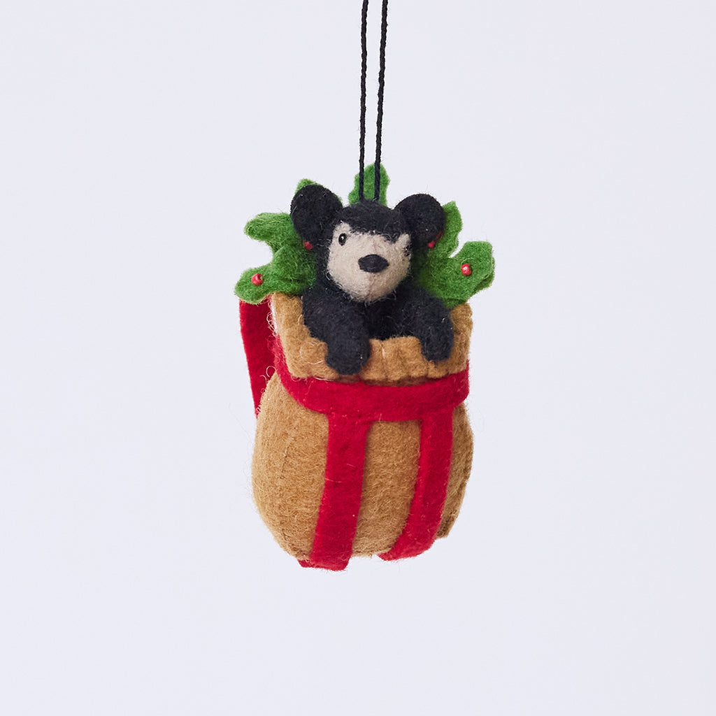 Handmade felt Adirondack Basket with Black Bear Cub ornament from Craftspring, featuring a rustic basket filled with holly and an adorable black bear cub peeking out—heirloom-quality Christmas decor, ethically crafted by artisans using sustainable wool.