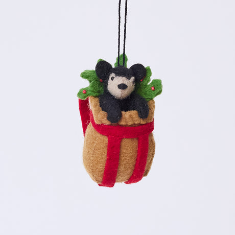 Handmade felt Adirondack Basket with Black Bear Cub ornament from Craftspring, featuring a rustic basket filled with holly and an adorable black bear cub peeking out—heirloom-quality Christmas decor, ethically crafted by artisans using sustainable wool.