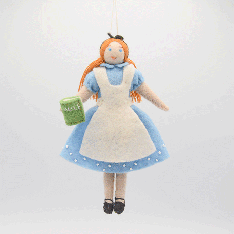 GIF of Alice from a set of three hand-felted wool ornaments inspired by Alice in Wonderland, including Alice in her blue dress holding a book, the grinning Cheshire Cat with black stripes, and the Caterpillar sitting on a mushroom with a hookah and the phrase 'Who are you?' stitched below. Each ornament features detailed embroidery, includes a hanging string, and is handmade from merino-blend wool.