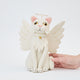 Handmade felt Angel Cat Tree Topper from Craftspring held in hand to show size—featuring white angel wings, a halo, a white collar with a bell, and gold embroidered details, ethically crafted by artisans using sustainable wool.