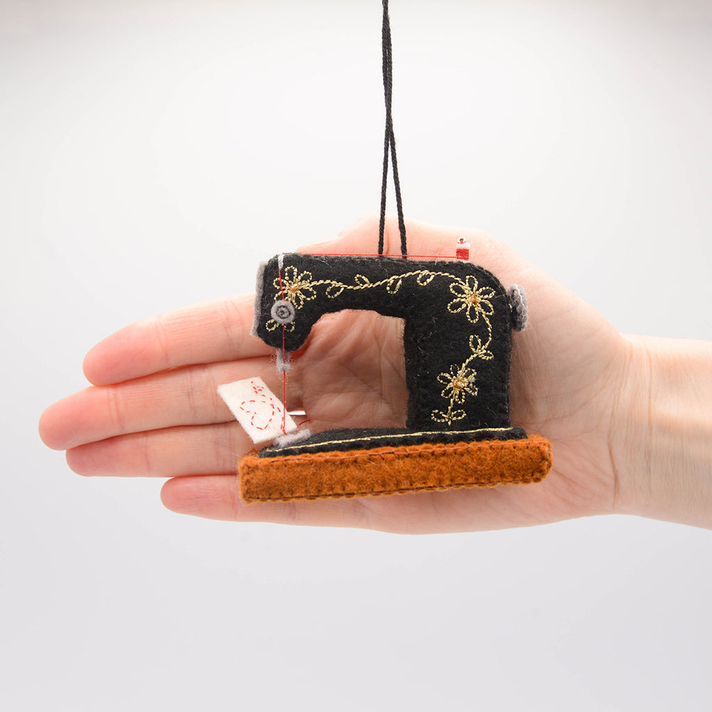 Hand-felted antique sewing machine ornament with gold details and thread spool, perfect for DIY lovers, crafters, and fashion creatives—ideal for Christmas décor and holiday gifting