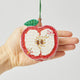 Beaded apple ornament with red and gold detail, handmade and fair trade.

