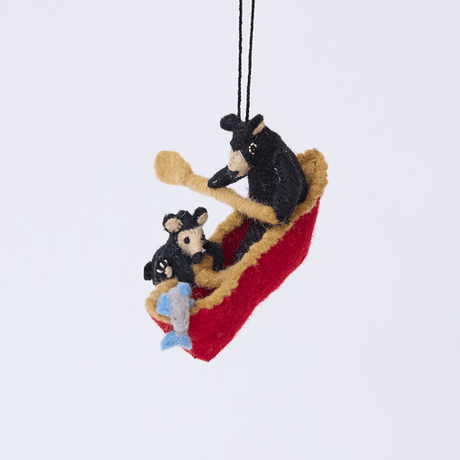 Handmade felt Bears in a Canoe ornament from Craftspring rotating to show front, side, and back views—featuring a mama bear paddling a canoe with a cub climbing over the side, ethically crafted by artisans using sustainable wool.
