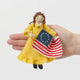 Celebrate the legendary maker associated with America’s first flag with our handcrafted Betsy Ross Ornament. Dressed in a bright colonial gown and holding the iconic early American flag, Betsy honors the spirit of independence, ingenuity, and handmade tradition.
