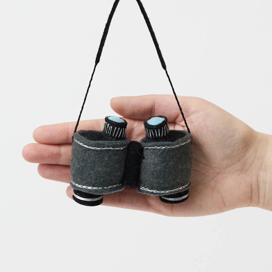 See the world through curious eyes with this hand-felted binoculars ornament, inspired by wildlife watching, outdoor exploration, and the thrill of discovering nature's hidden wonders.