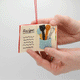 Miniature felt ornament shaped like a cookbook, hand-felted and embroidered with cooking-themed details including salt, pepper, vegetables, and a stovetop. Crafted from merino-blend wool with soft pages and a hanging string, this ornament measures approximately 2.5 inches tall. A cozy tribute to home cooking and culinary tradition. 360 degree of book pages. 