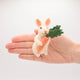 Whimsical needle-felted bunny with carrot, ideal for nursery decor or Easter gifting