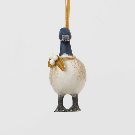 A vintage-inspired Canada Goose Resin Ornament, hand-painted in the Philippines with classic black-and-white markings, a golden metal holly necklace, and satin hanging ribbon.
