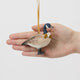 A vintage-inspired Canada Goose Resin Ornament, hand-painted in the Philippines with classic black-and-white markings, a golden metal holly necklace, and satin hanging ribbon.