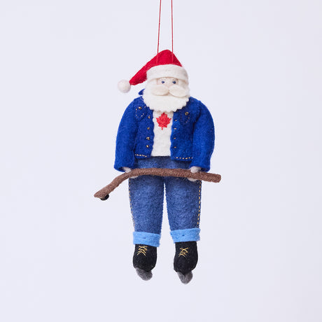 Craftspring’s Canadian Santa Ornament — made of felt, wearing a denim jacket and jeans, ice skates, and holding a hockey stick, with a Canadian flag maple leaf on his shirt — heirloom-quality Christmas ornament, perfect for holiday gifting, ethically crafted by artisans using sustainable wool.