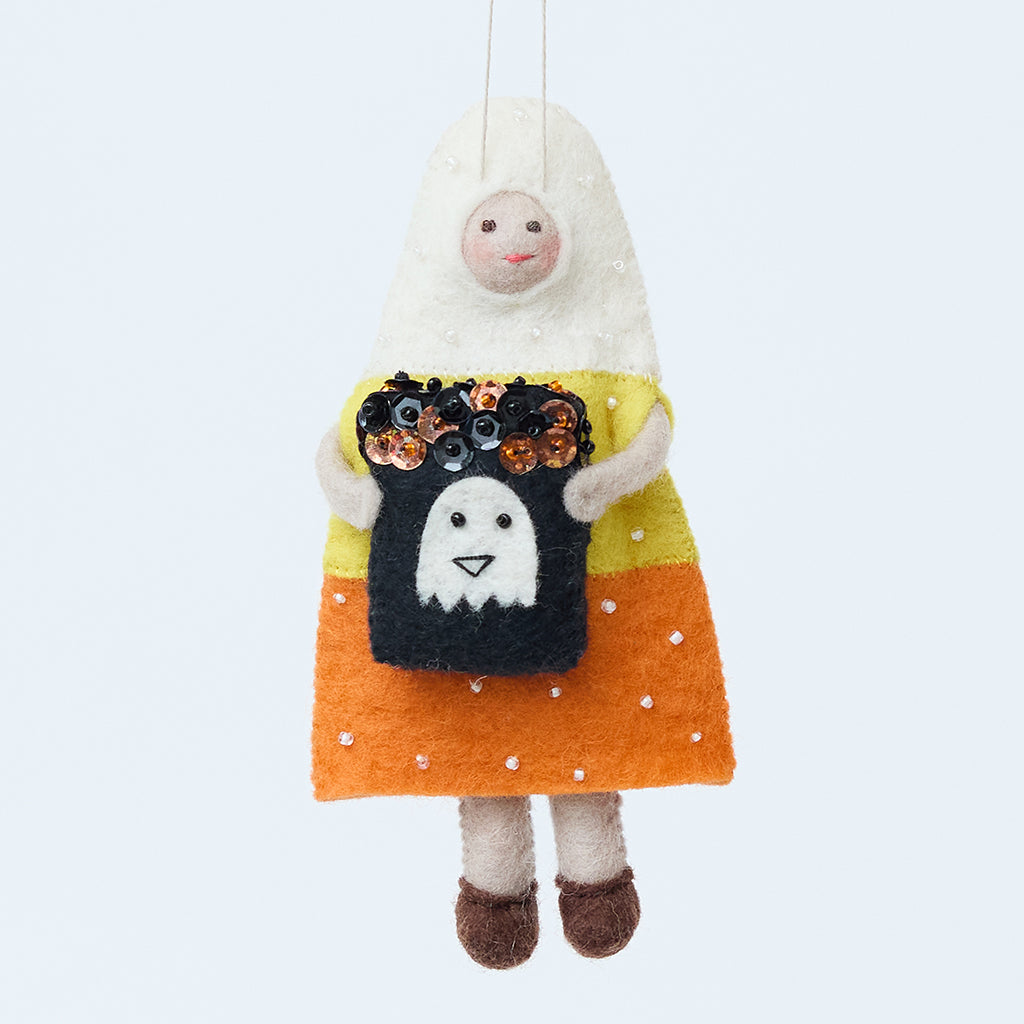 Handmade felt Candy Corn Trick-or-Treater Ornament from Craftspring, wearing a beaded candy corn costume and holding a bag filled with beaded and embroidered candy—heirloom-quality Halloween decor, ethically crafted by artisans using sustainable wool.