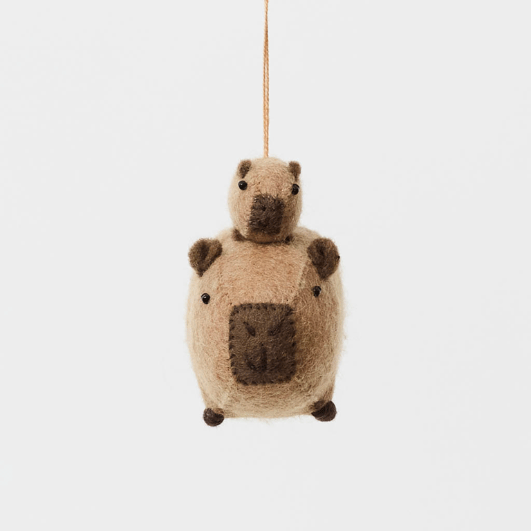 A handmade felt capybara and baby ornament from Kyrgyzstan. Cute as can be —perfect for meaningful gifting and cozy decor.