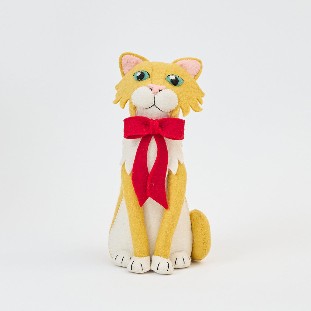 Handmade felt Orange Cat Tree Topper from Craftspring, featuring a festive red bow and detailed stitching—heirloom-quality holiday decor perfect for playful cat lovers, ethically crafted by artisans using sustainable wool.