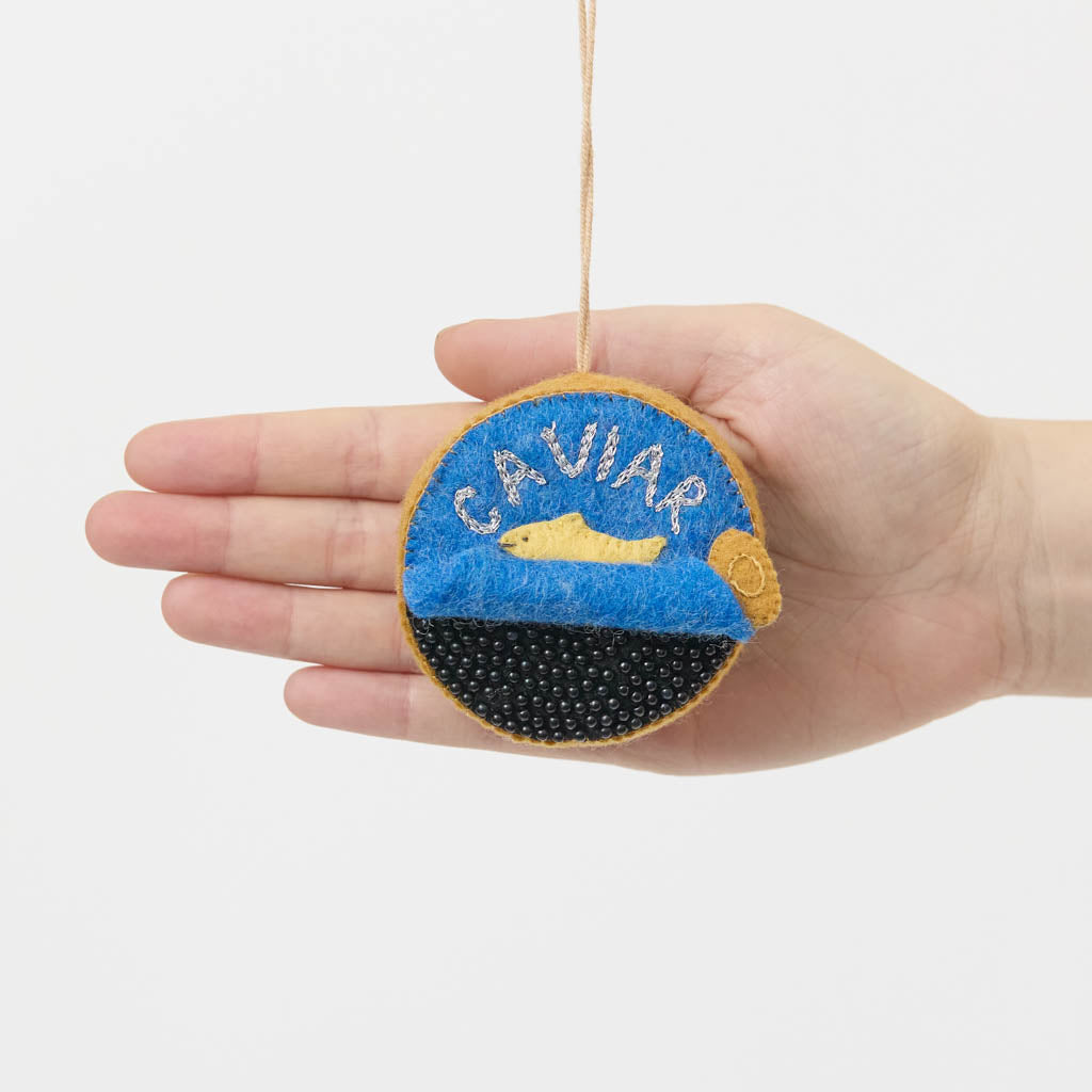 Celebrate life's finest moments with our handmade Caviar Tin Ornament, a luxurious felt keepsake inspired by gourmet entertaining, champagne toasts, and unforgettable celebrations.