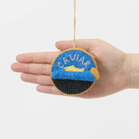 Celebrate life's finest moments with our handmade Caviar Tin Ornament, a luxurious felt keepsake inspired by gourmet entertaining, champagne toasts, and unforgettable celebrations.