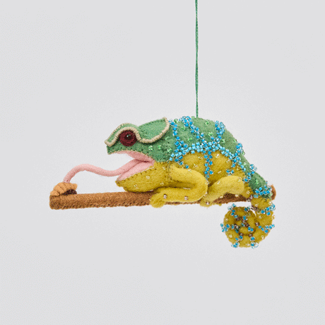 Handmade felt Chameleon ornament from Craftspring rotating to show front, side, and back views—featuring beaded details, a curled tail, and a long tongue catching a bug, ethically crafted by artisans using sustainable wool.