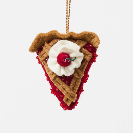 A true slice of nostalgia, our Cherry Pie Slice Ornament captures the timeless charm of one of America's favorite desserts. Handcrafted from natural wool felt, this delightful ornament features a rich cherry filling accented with sparkling red beadwork, a beautifully detailed lattice crust, a dollop of whipped cream, and a bright cherry on top.