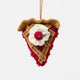 A true slice of nostalgia, our Cherry Pie Slice Ornament captures the timeless charm of one of America's favorite desserts. Handcrafted from natural wool felt, this delightful ornament features a rich cherry filling accented with sparkling red beadwork, a beautifully detailed lattice crust, a dollop of whipped cream, and a bright cherry on top.