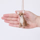 Craftspring’s Chihuahua Ornament displayed in front of a hand to show its size—needle-felted with big ears and a charming face, ethically crafted by artisans using sustainable wool.