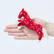 Craftspring’s Chinese Red Horse Ornament shown in front of a hand to display its size — handmade from sustainable wool with intricate beaded and embroidered Lunar New Year details, ethically crafted by artisans using sustainable wool.