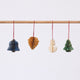 Craftspring’s Classic Christmas Honeycomb Paper Mini Ornaments — Set of 4, featuring a snowman, bell, pinecone, and tree, each in a different color with gold sparkly edges — handmade by artisans from recycled cotton waste, perfect for Christmas decorating.
