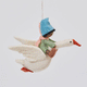 Handmade felt Cloud Dancer Dream Goose ornament – Brown – from Craftspring rotating to show front, side, and back views—featuring a detailed baby with brown skin and black hair riding a white goose, showcasing artisan craftsmanship and intricate stitching, ethically crafted using sustainable wool.