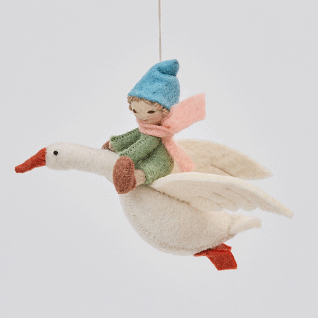 Handmade felt Cloud Dancer Dream Goose Ornament – Light from Craftspring rotating to show front, side, and back views—featuring a detailed baby with light skin and blonde hair riding a flying white goose, showcasing artisan craftsmanship and intricate stitching, ethically crafted using sustainable wool.