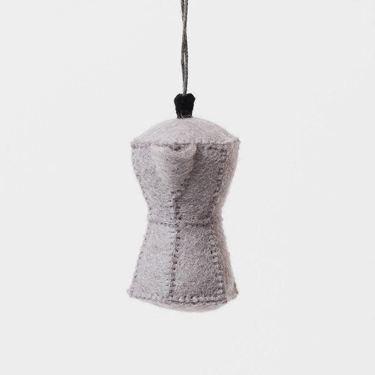 Handcrafted from natural wool felt, this charming ornament is inspired by the classic stovetop camping percolator—a beloved companion for generations of campers, hikers, RV travelers, and cabin lovers. Its timeless silhouette, soft neutral tones, and handcrafted stitching evoke memories of peaceful mornings surrounded by towering pines, fresh mountain air, and the sounds of nature waking up.