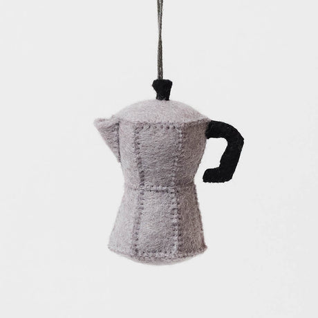 Handcrafted from natural wool felt, this charming ornament is inspired by the classic stovetop camping percolator—a beloved companion for generations of campers, hikers, RV travelers, and cabin lovers. Its timeless silhouette, soft neutral tones, and handcrafted stitching evoke memories of peaceful mornings surrounded by towering pines, fresh mountain air, and the sounds of nature waking up.