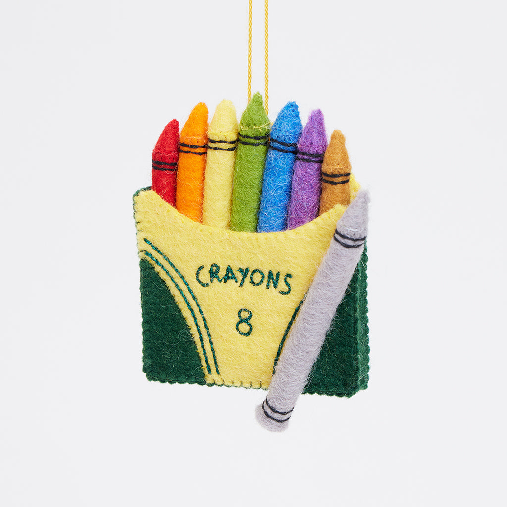 Felt crayon box ornament featuring bright wool crayons in stitched yellow case. Perfect for teacher gifts, young artists, or colorful holiday décor.