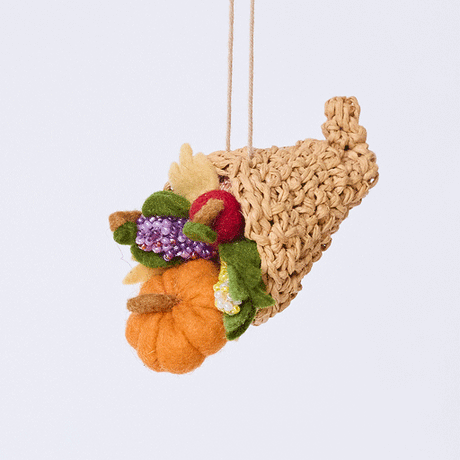 Handmade felt Cornucopia ornament from Craftspring rotating to show front, side, and back views—featuring a crocheted raffia cornucopia filled with felt and beaded vegetables and fruit, ethically crafted by artisans using sustainable wool.