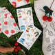 Colorful vinyl stickers of fresh produce – carrots, peas, berries, and more on a waterproof sheet for food lovers and garden fans.