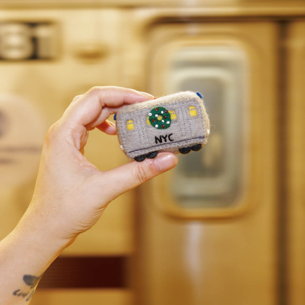 Celebrate the rhythm of New York City with our handmade NYC Subway Train Car Ornament, a charming felt keepsake inspired by the iconic subway cars that keep the city moving.