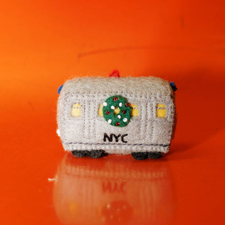 Celebrate the rhythm of New York City with our handmade NYC Subway Train Car Ornament, a charming felt keepsake inspired by the iconic subway cars that keep the city moving.