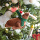 Craftspring’s Santa Walrus Ornament — a charming walrus wearing a Santa hat and a cozy holiday scarf with embroidered details — displayed on a glowing Christmas tree, bringing whimsical warmth, festive delight, and gift-ready Christmas cheer, ethically crafted by artisans using sustainable wool.