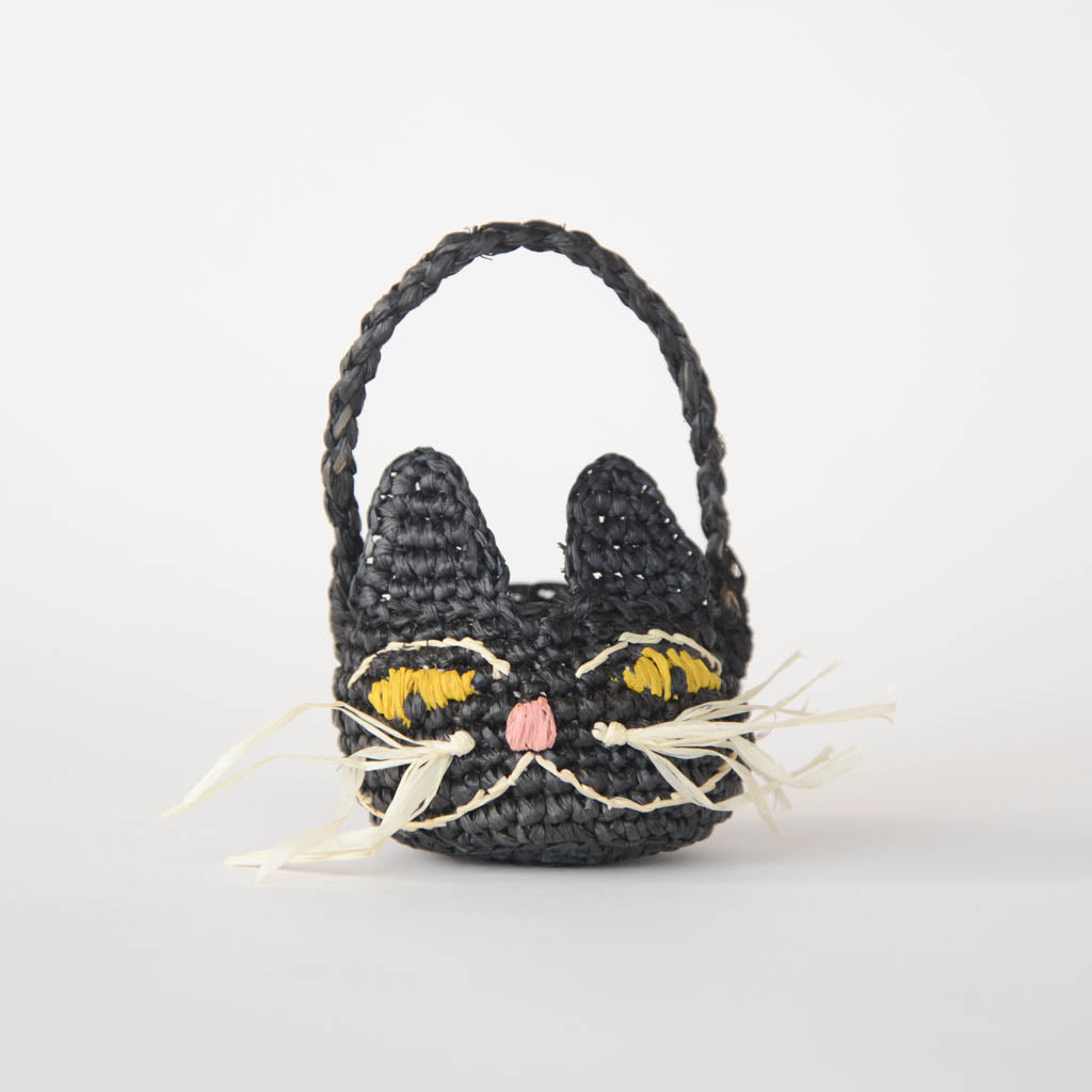 Adorably hand-crocheted, this black cat is ready for autumnal nights! Soft, lightweight, and ethically made, our mini raffia basket is perfectly sized for a little touch of joy. Fill it with treats and treasures for your fall table.&nbsp;