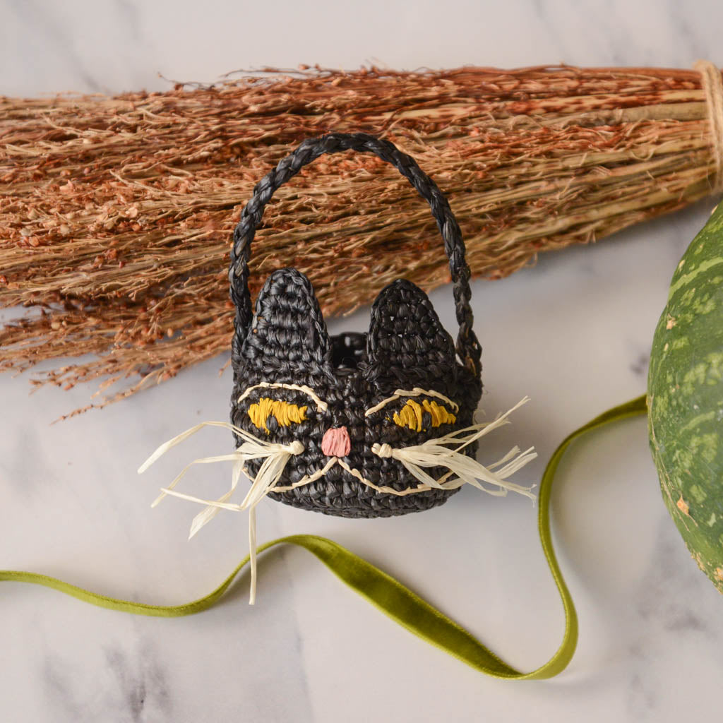 Adorably hand-crocheted, this black cat is ready for autumnal nights! Soft, lightweight, and ethically made, our mini raffia basket is perfectly sized for a little touch of joy. Fill it with treats and treasures for your fall table.&nbsp;