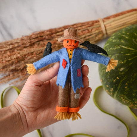 Under the bright full moon, our pumpkin scarecrow is too cute to scare. With two black crows on its shoulders and patches on its clothes, it's our favorite autumnal field-hand. Tie it to a trick-or-treating pumpkin, nestle it on a shelf, or add it to a tree for some Halloween fun!