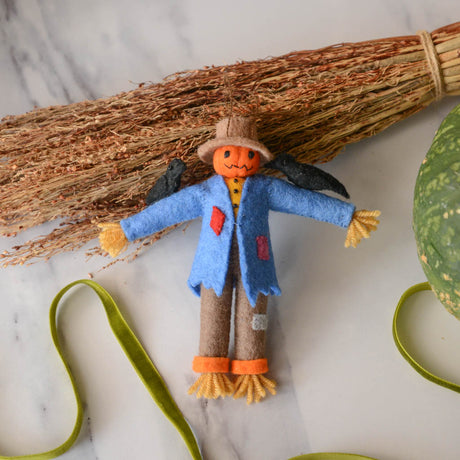 Under the bright full moon, our pumpkin scarecrow is too cute to scare. With two black crows on its shoulders and patches on its clothes, it's our favorite autumnal field-hand. Tie it to a trick-or-treating pumpkin, nestle it on a shelf, or add it to a tree for some Halloween fun!