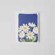 A daisy greeting card with ladybug.  Part of Merci Gift Box Set featuring a felt blueberry ornament, white daisy flower bouquet in vase, and daisy greeting card. Handmade from wool felt with French-inspired floral charm. Fair trade and ready to gift.